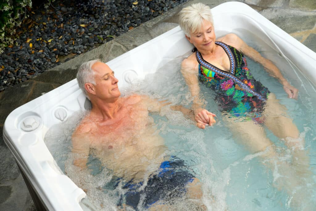 couple enjoying 3-person hot tub
