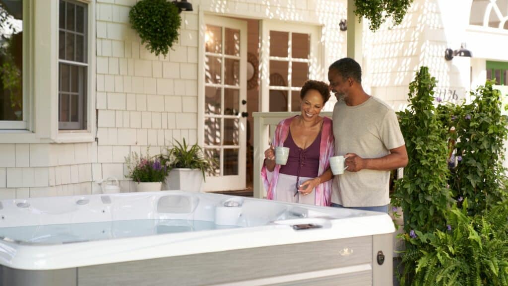A couple looking at their new hot tub after shopping local instead of from a hot tub expo