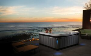 Two people sitting in a saltwater hot tub enjoying the sunset.